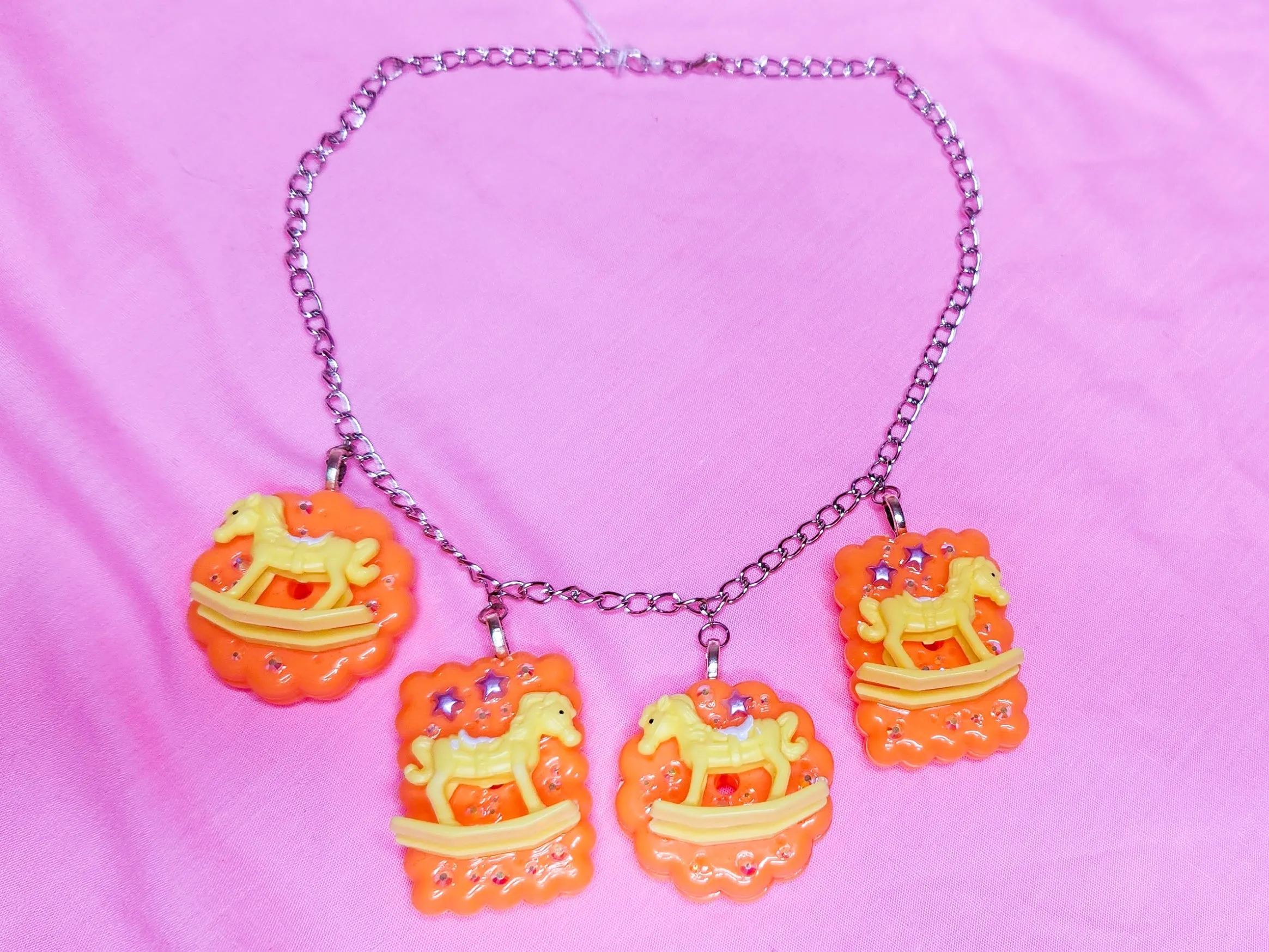 Orange cracker biscuit rocking horse charm necklace