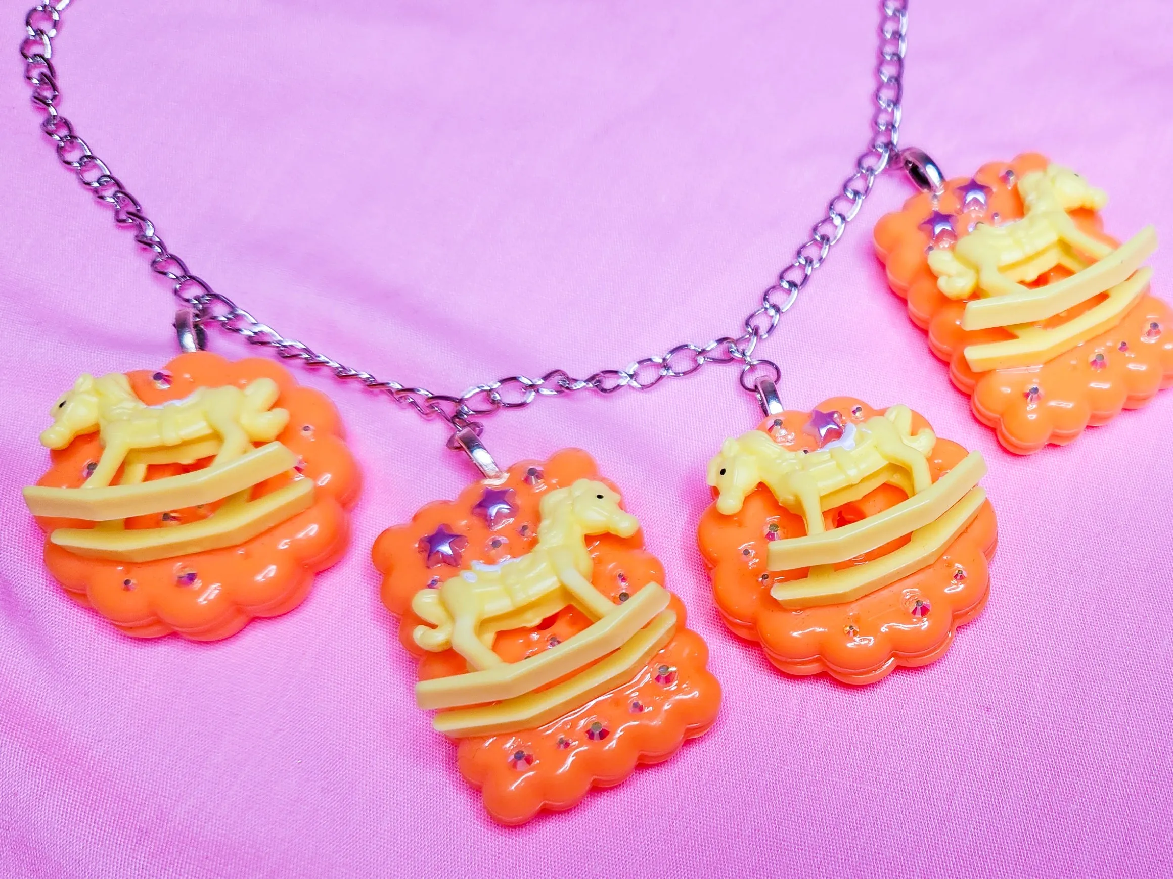 Orange cracker biscuit rocking horse charm necklace